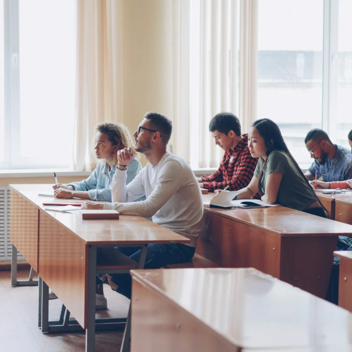 Teacher instructing students in a classroom lecture.